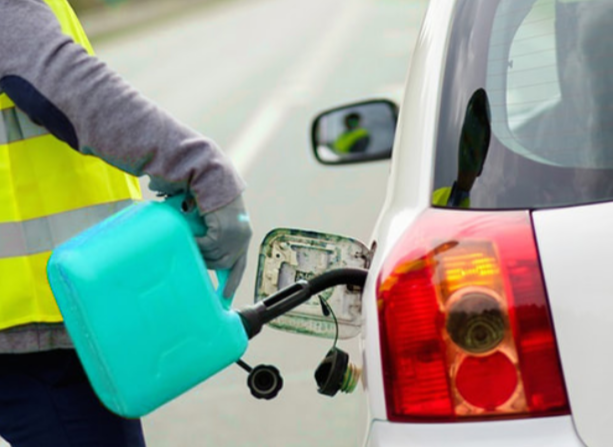 Picture of a person fueling a vehicle with a jerry can.