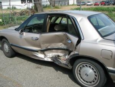 Picture of a smashed up vehicle. The vehicle has been in a car accident and is no longer drivable.