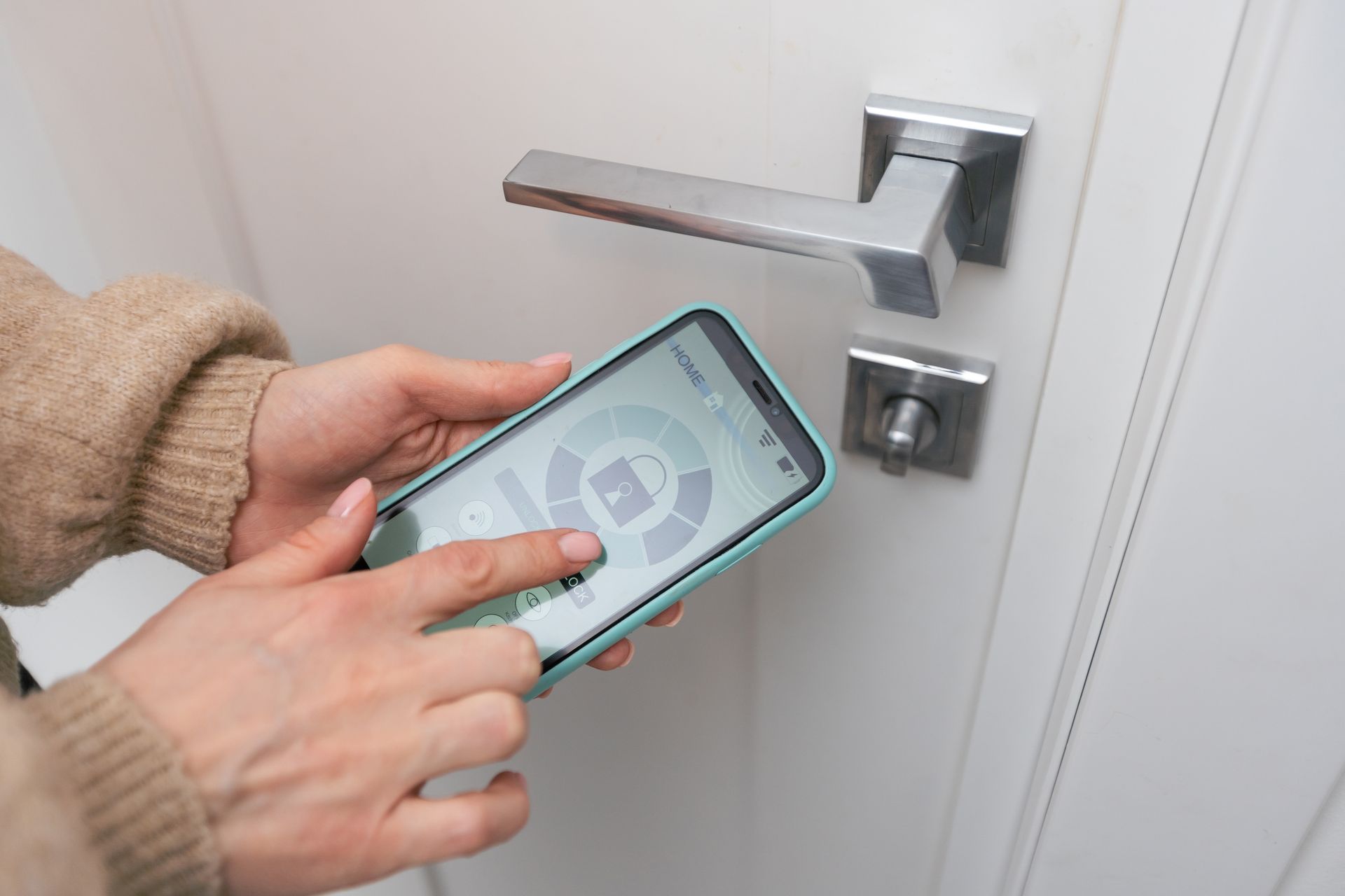 A person is using a smart phone to lock a door.