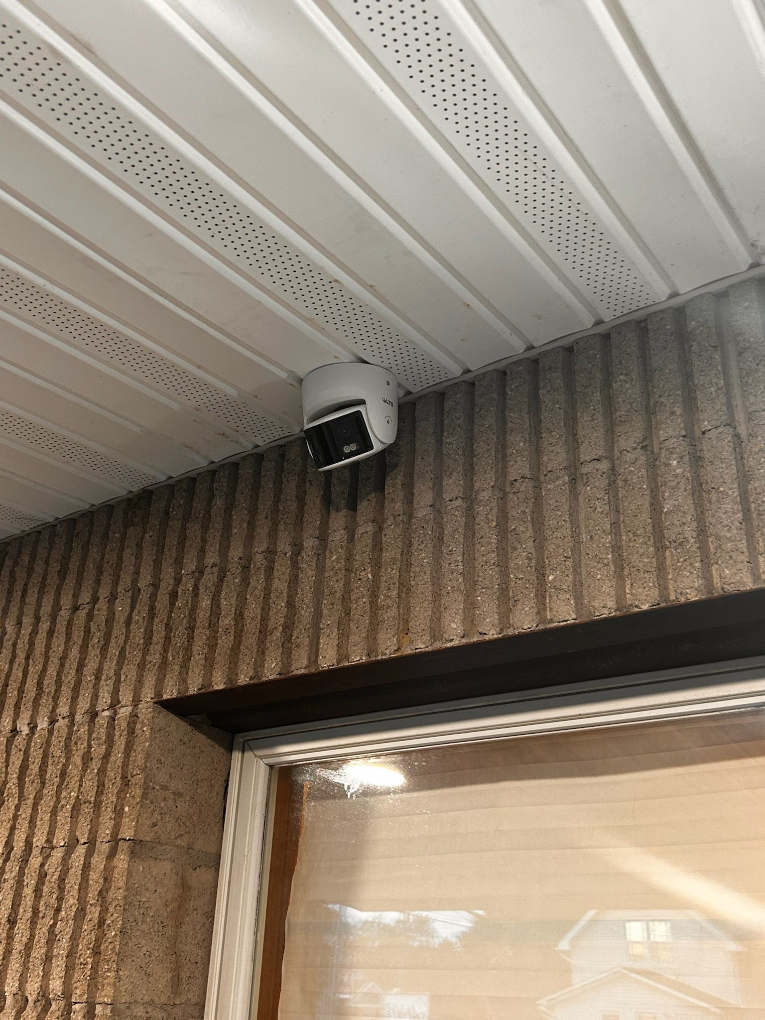 A security camera is attached to a metal pole