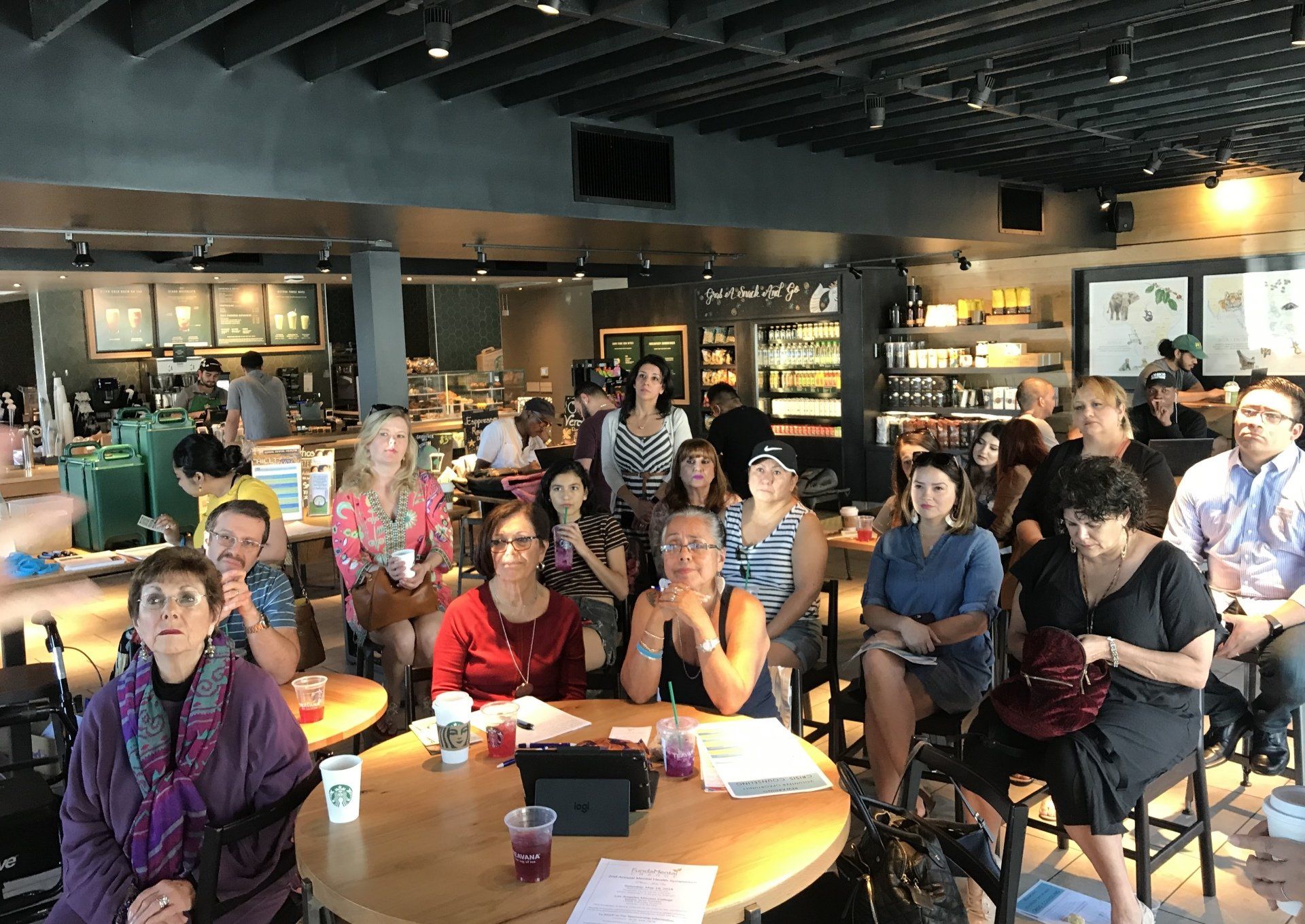 A group of people are sitting at tables in a restaurant.