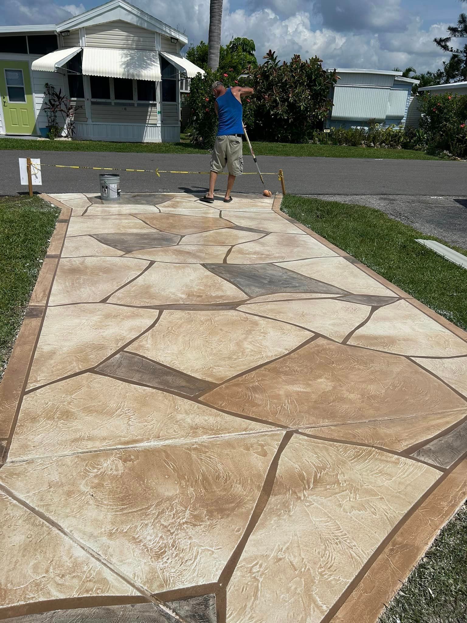 small concrete driveway with multi colored stain pattern and sealant