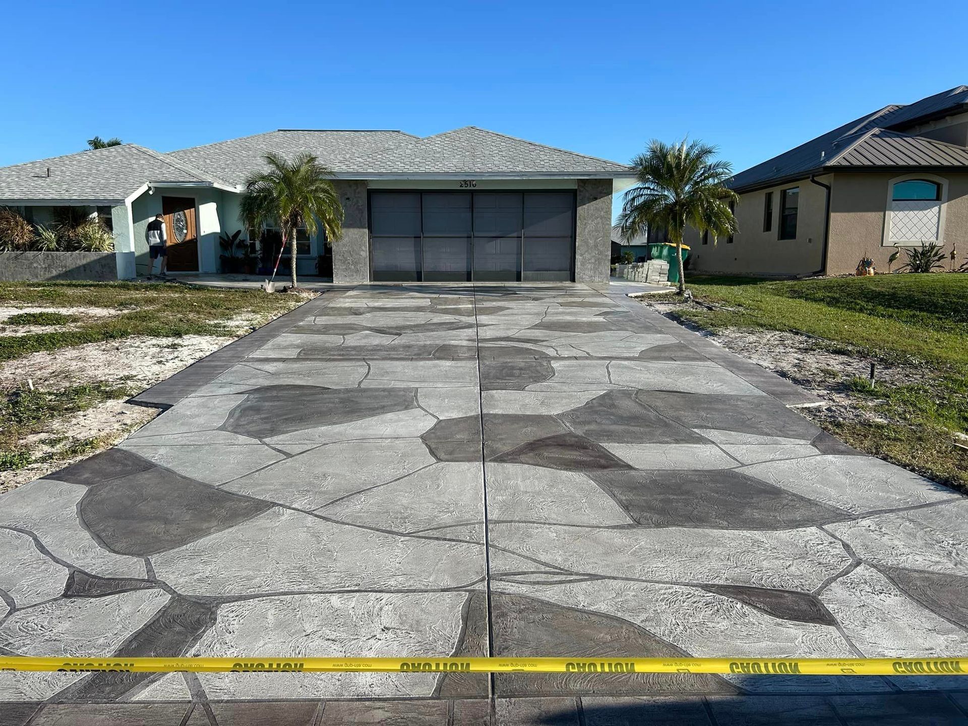 Decorative stamped concrete driveway with stain and sealant