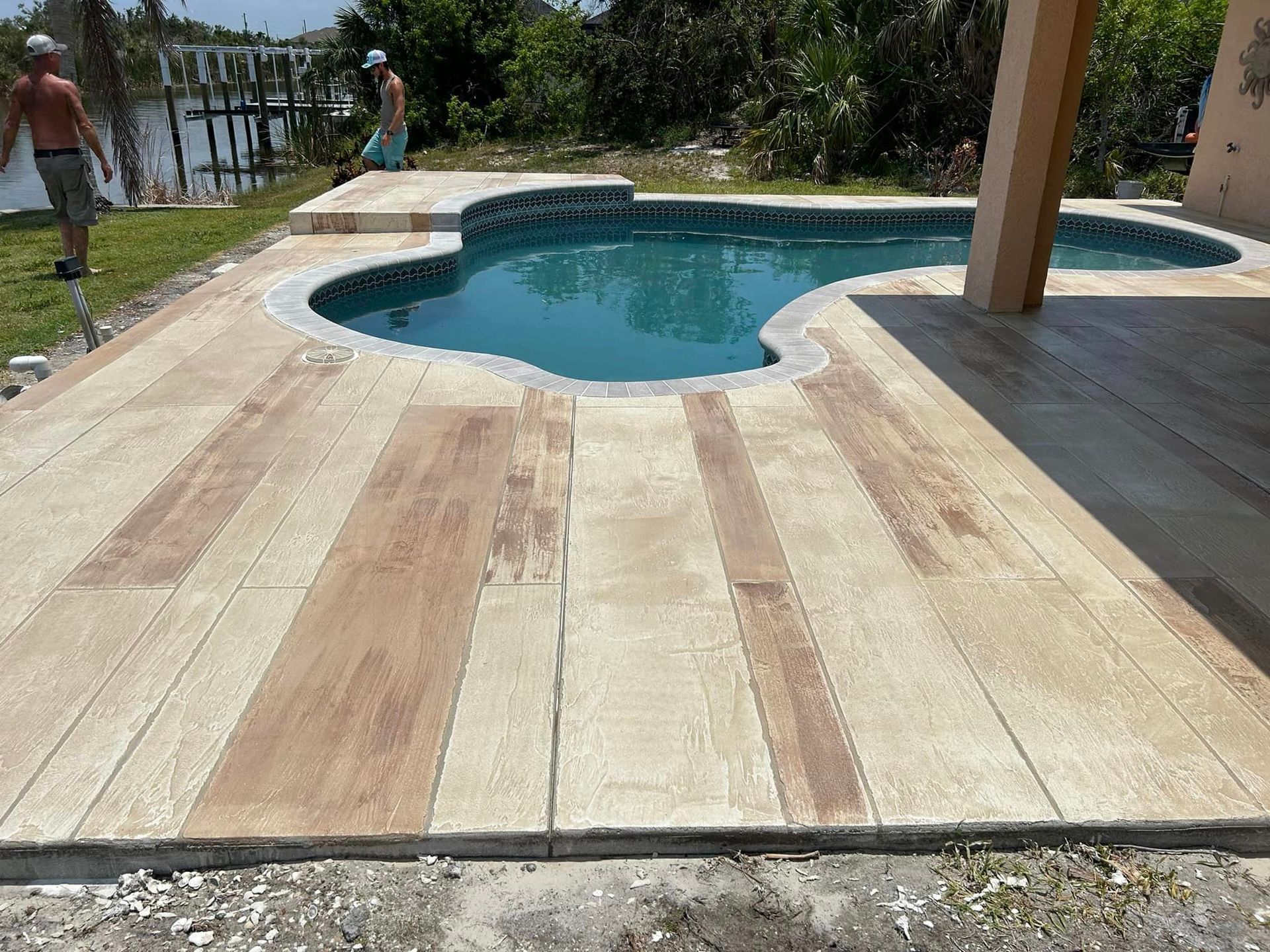 Wood-look pool deck with stain and sealant