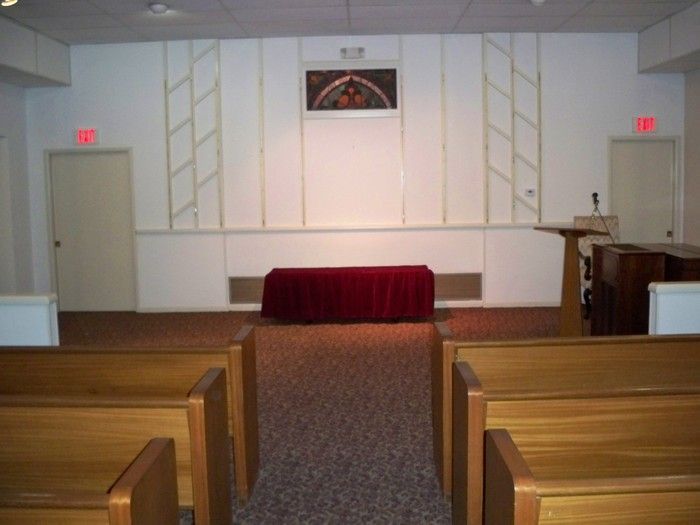 An empty church with a red table in the middle