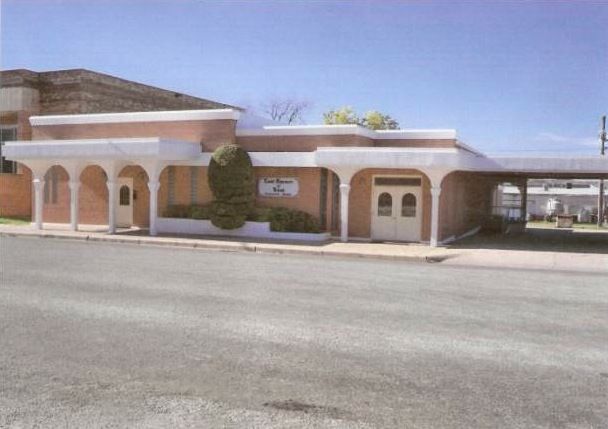 A brick building with a white awning on top of it