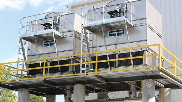 Industrial equipment platform with metal tanks, railings, and ladders on an elevated structure