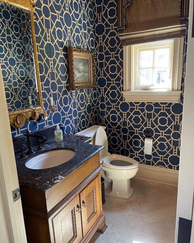 A bathroom with a sink , toilet and mirror