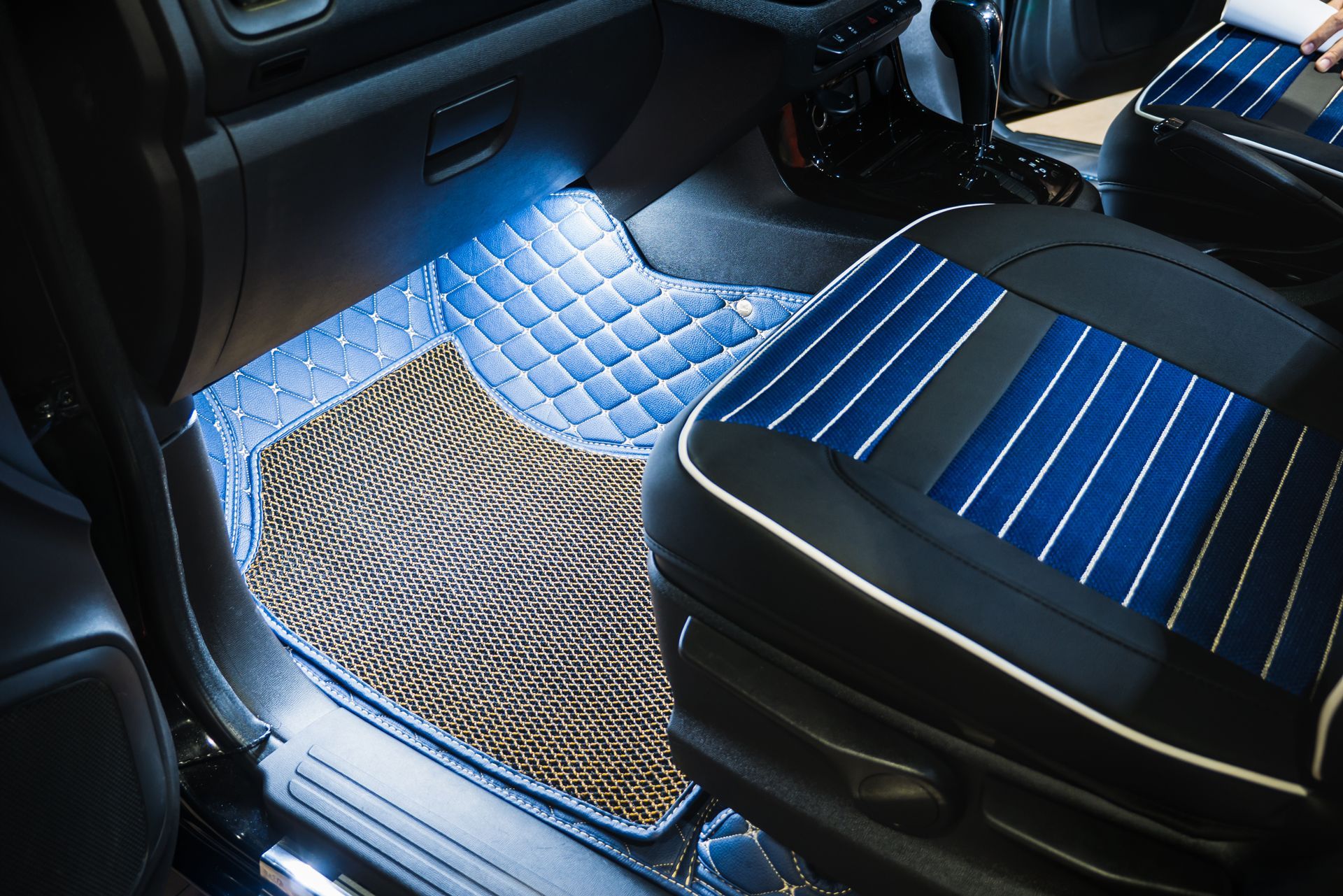 The Interior of a Car With Blue and Black Seat Covers