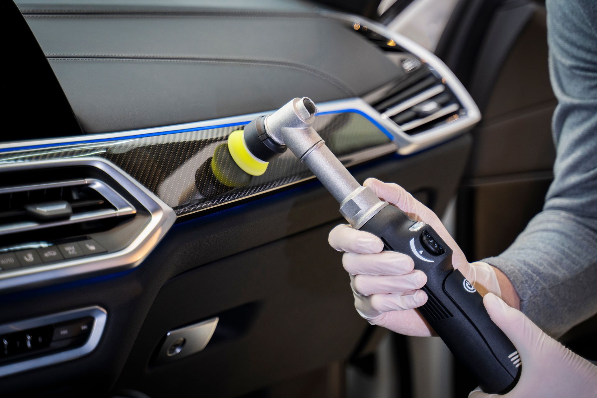A Person is Polishing the Interior of a Car With a Machine
