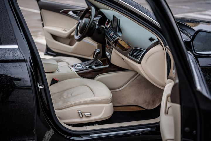 The Interior of a Black Car With the Door Open