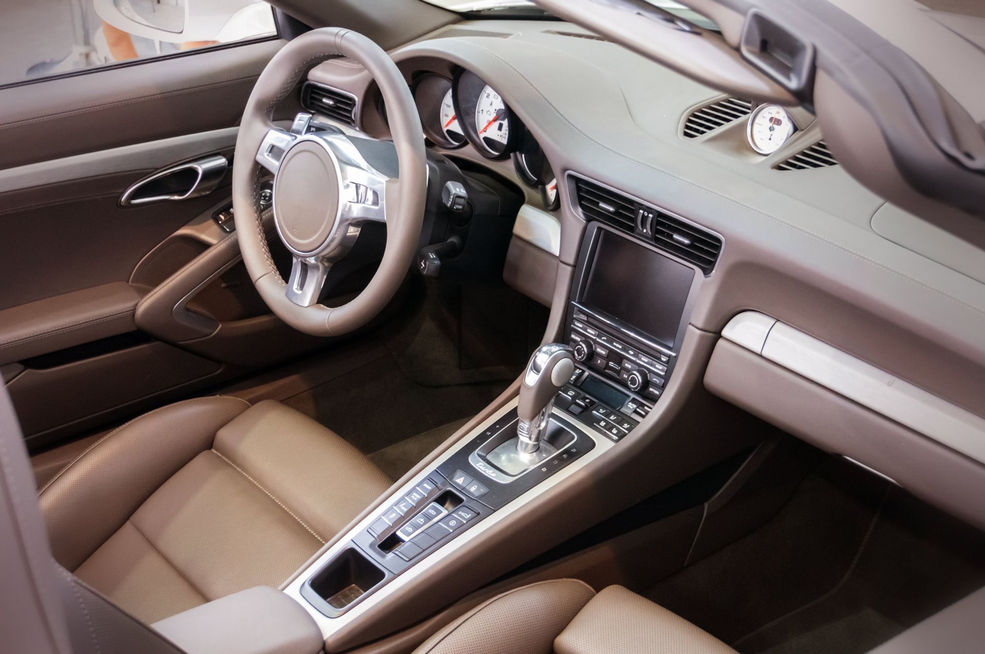 The Interior of a Car With a Steering Wheel and Dashboard