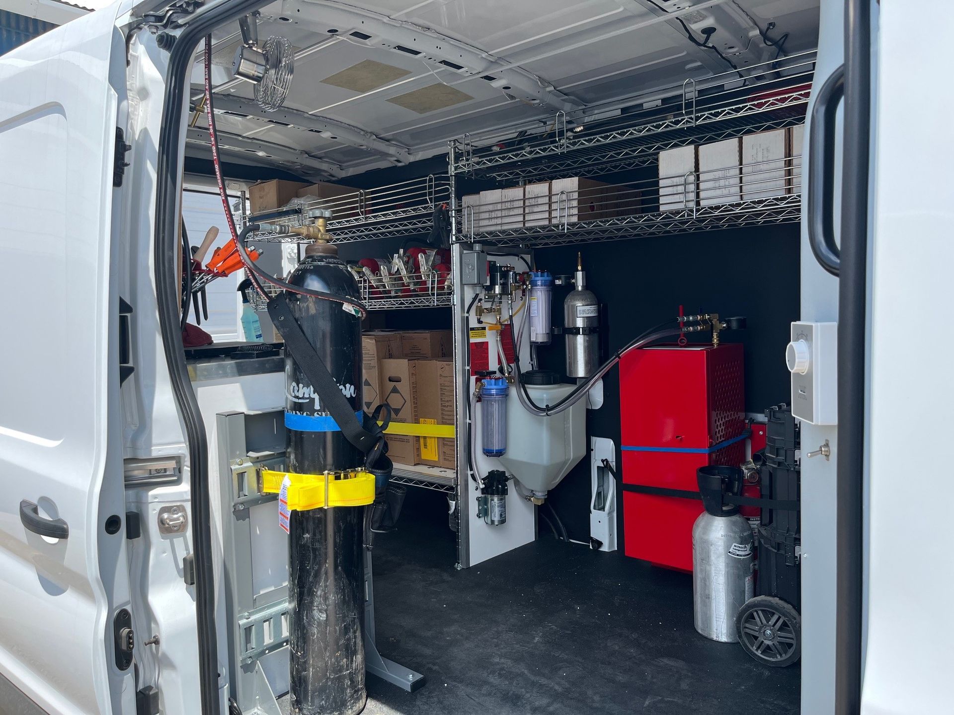 A white van with a lot of tools in it