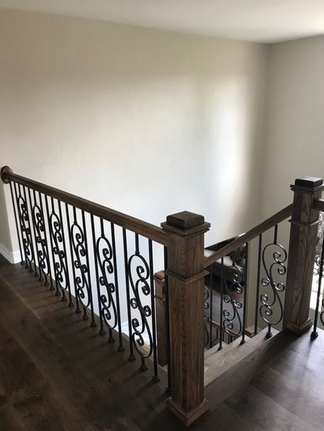 a wooden and metal stair railing in a house