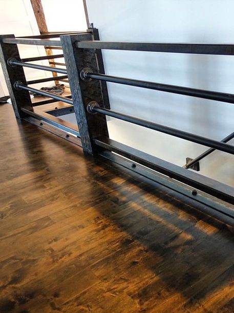a wooden floor with a metal railing on top of it