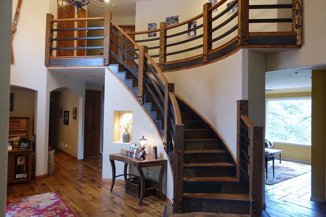 a spiral staircase in a home with hardwood floors