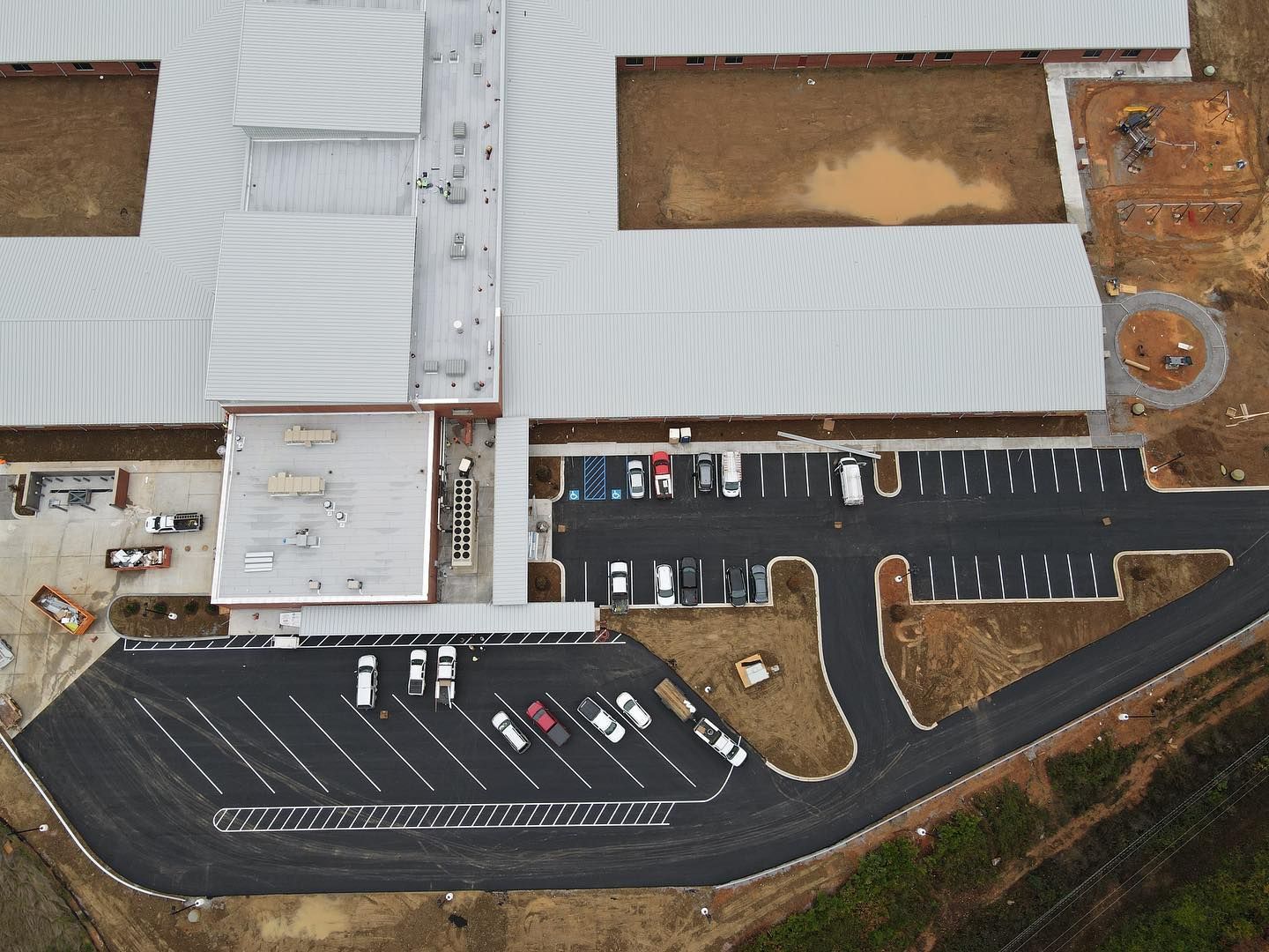 An aerial view of a building with a parking lot in front of it