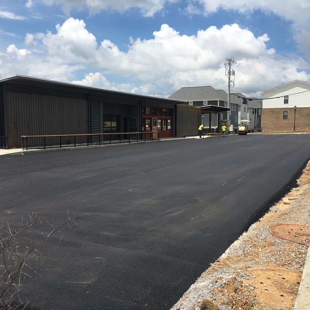 A parking lot with a building in the background