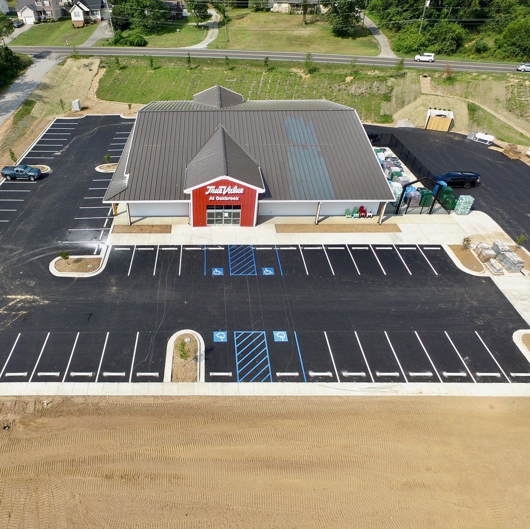 An aerial view of a building with a parking lot in front of it