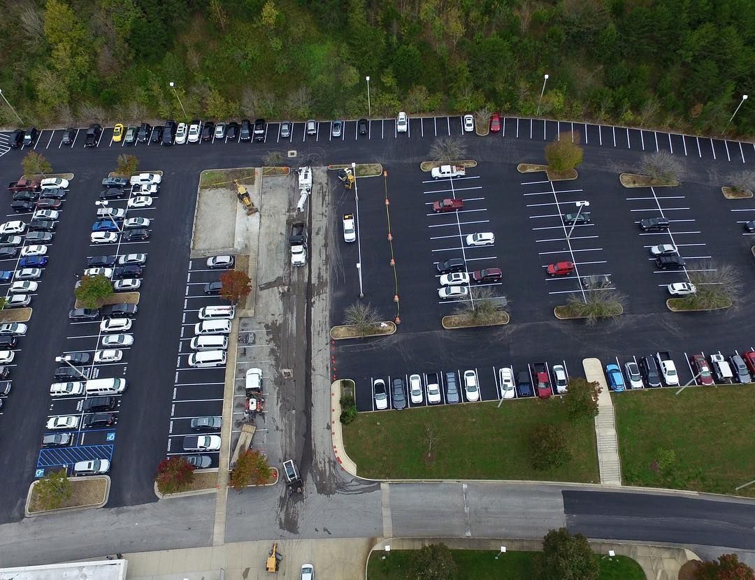 An aerial view of a parking lot filled with cars