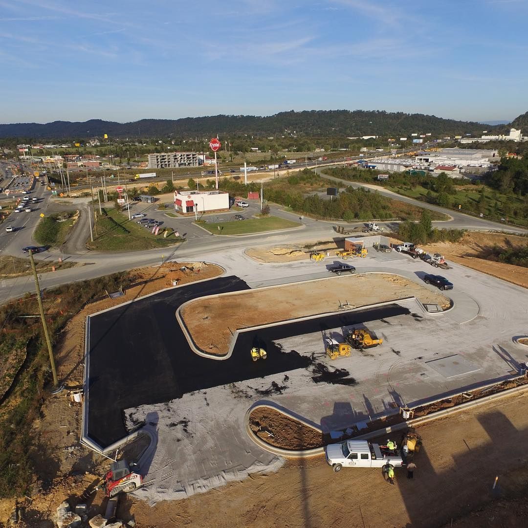 An aerial view of a construction site with a truck parked in the middle of it.