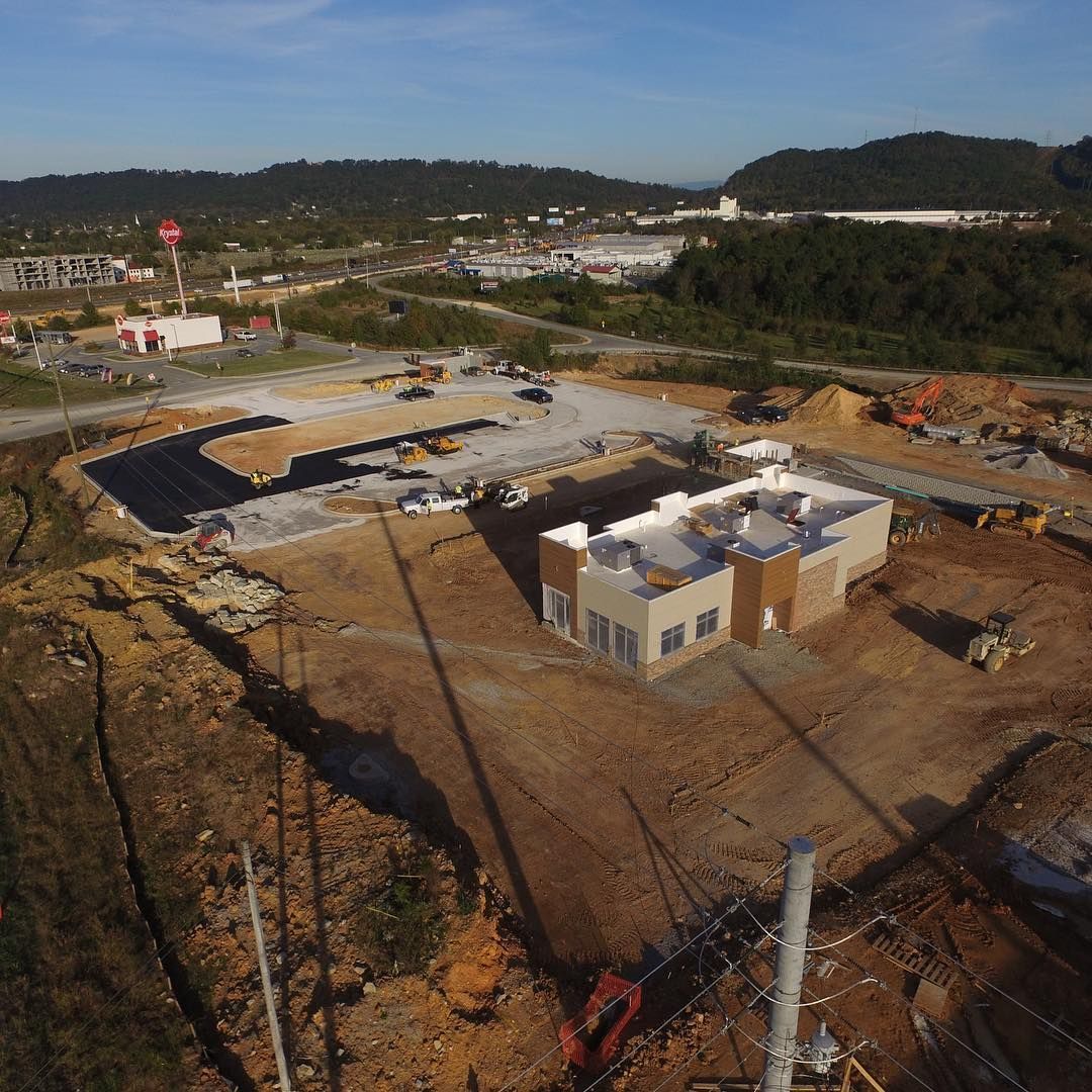 An aerial view of a construction site with a building under construction