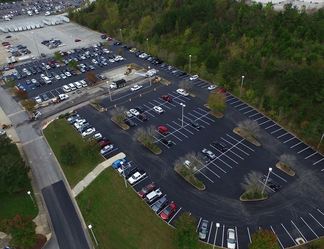 An aerial view of a parking lot filled with cars