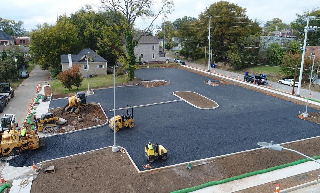 An aerial view of a parking lot being built in a city.