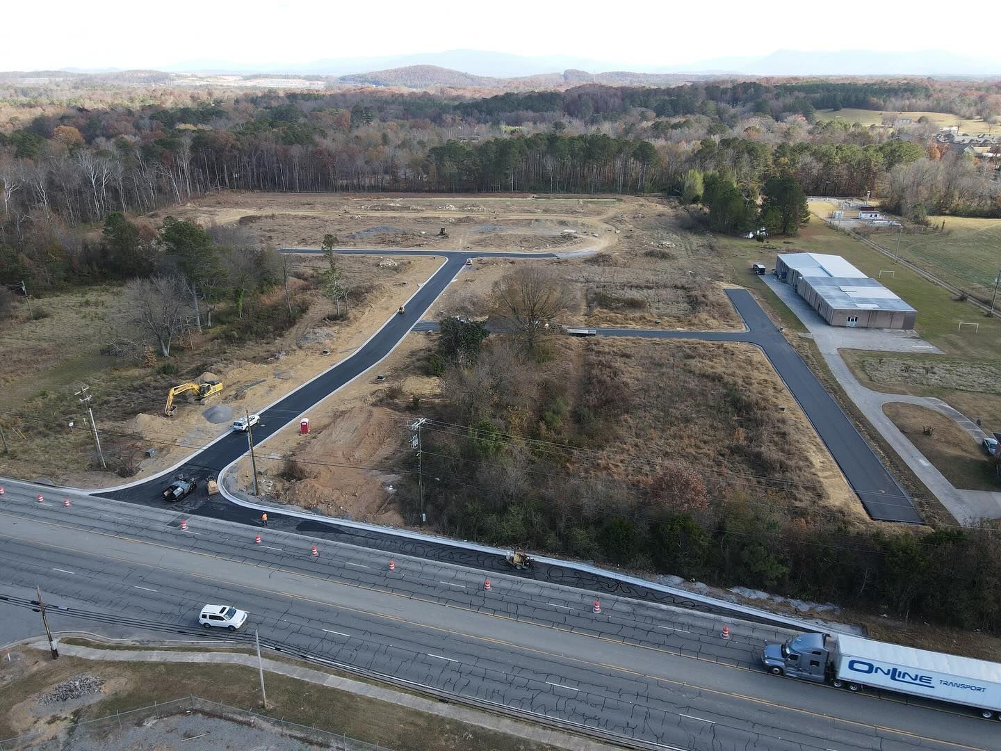 An aerial view of a truck driving down a highway.