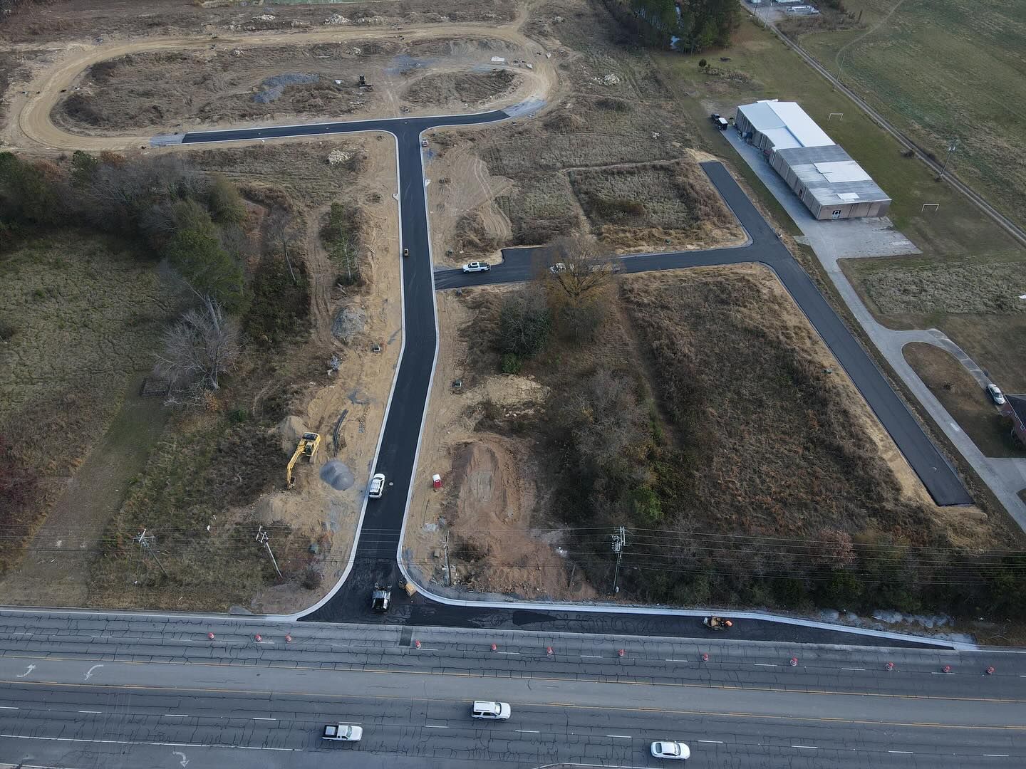 An aerial view of a construction site with a road going through it