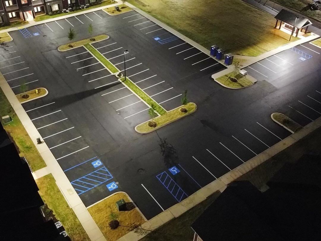 An aerial view of a parking lot at night.