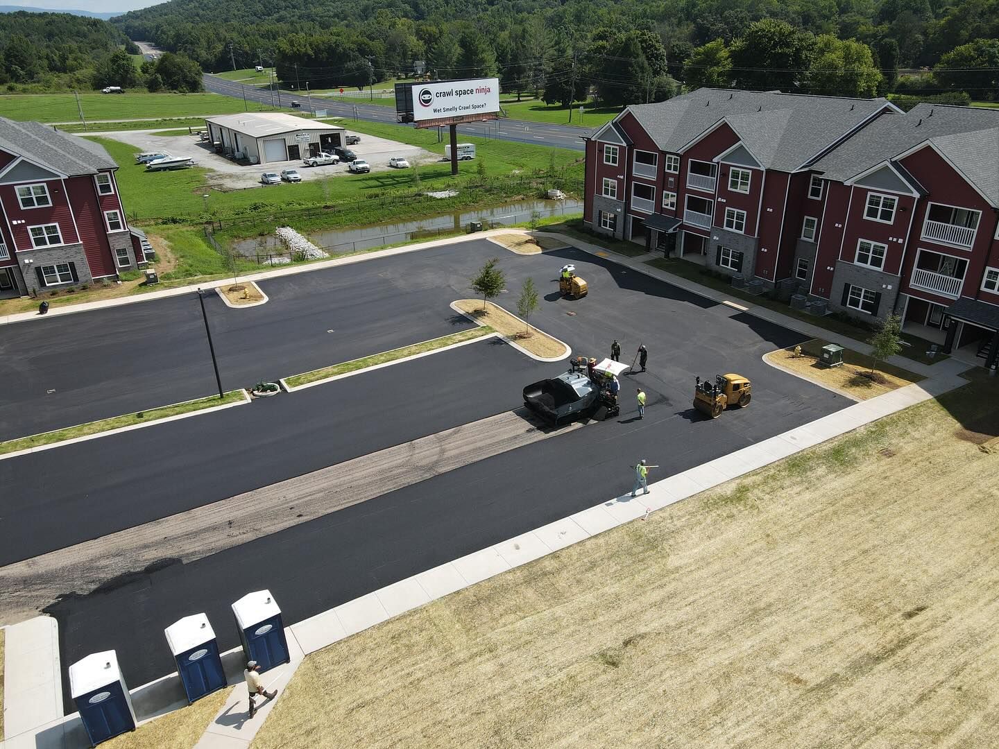 An aerial view of a parking lot in front of a building