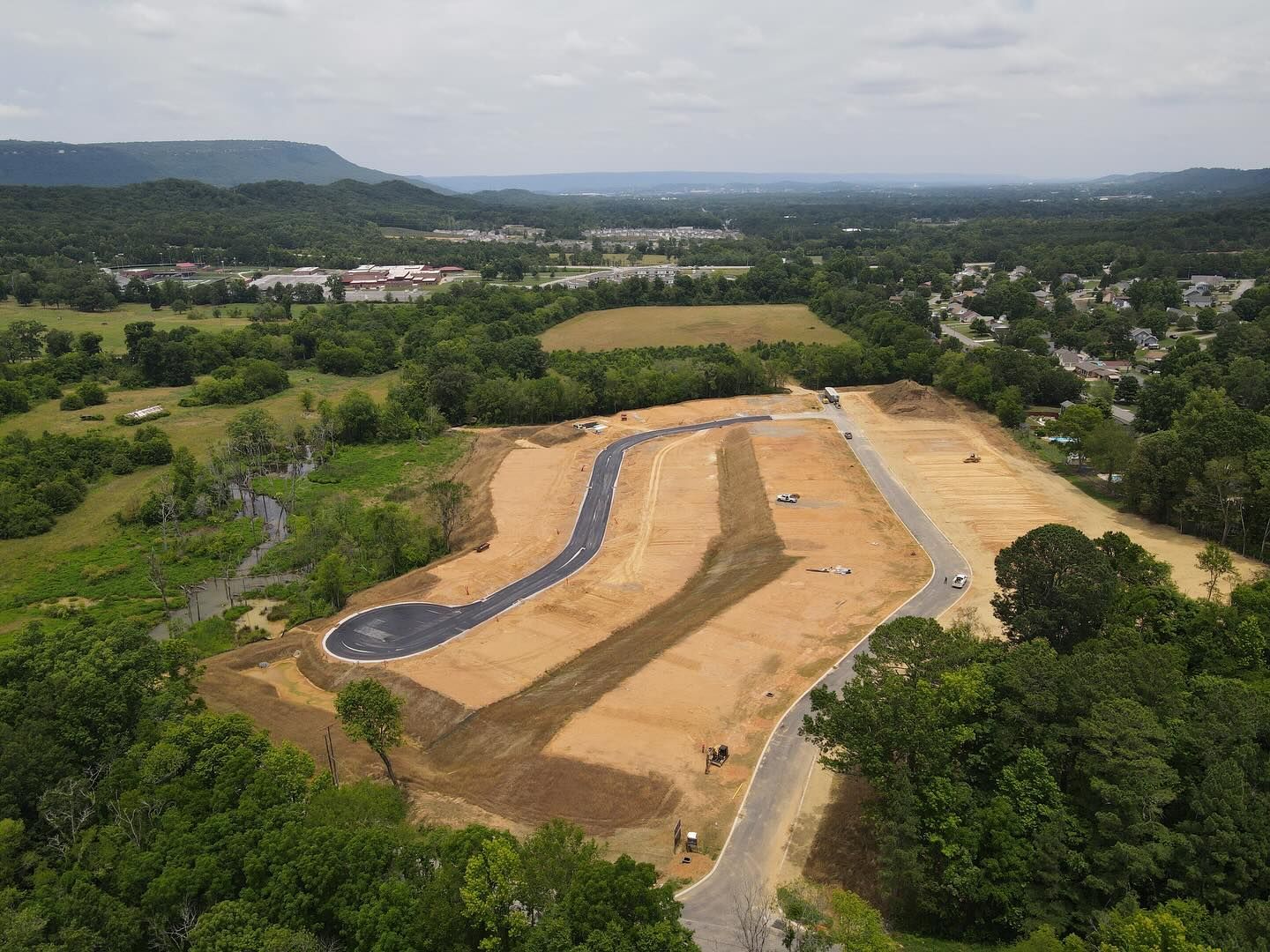 An aerial view of a residential development under construction in the mountains.