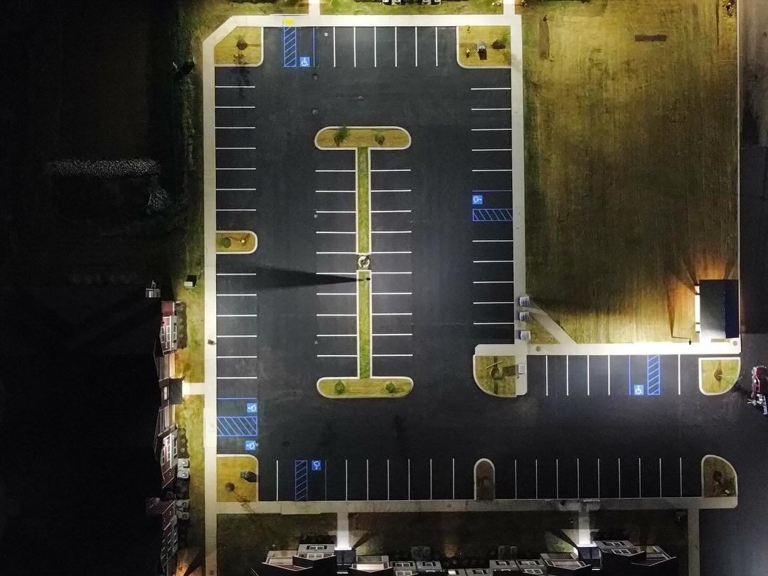 An aerial view of a parking lot at night.