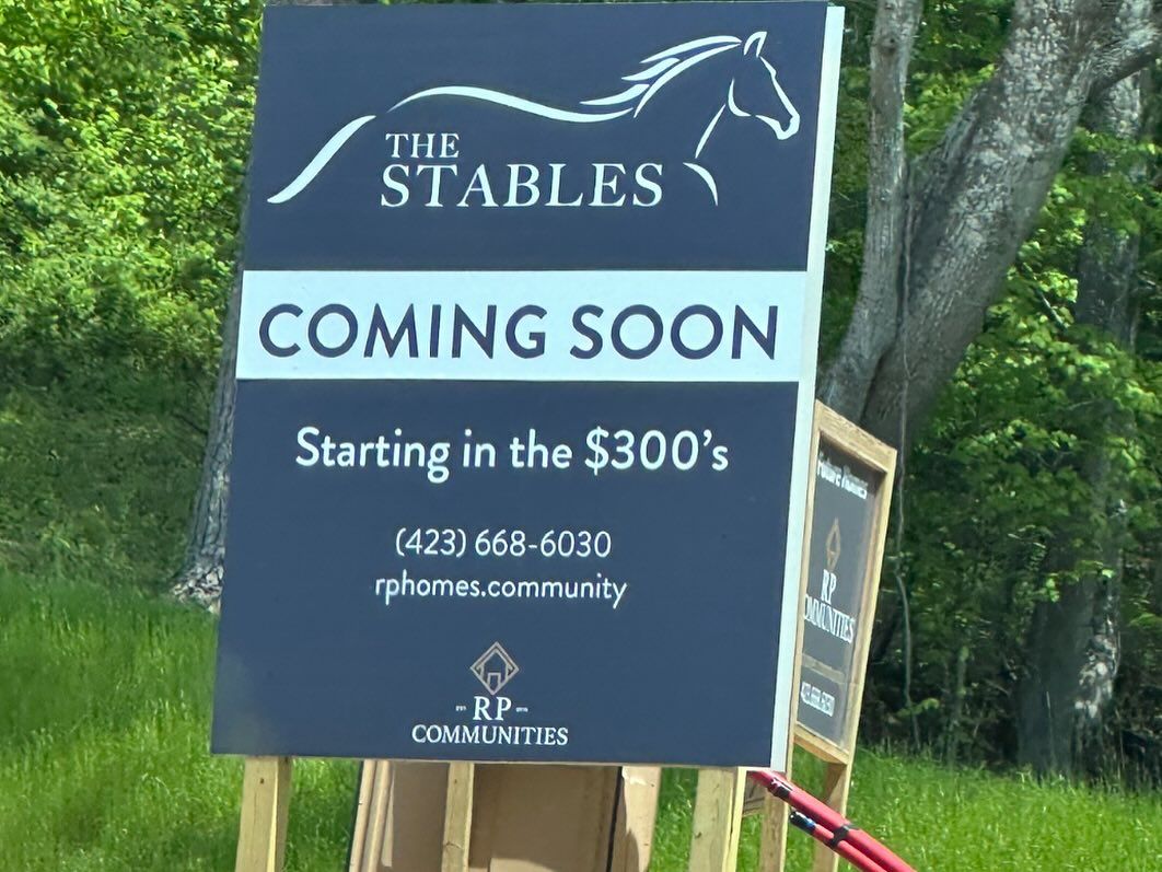 A sign that says ' the stables coming soon ' on it