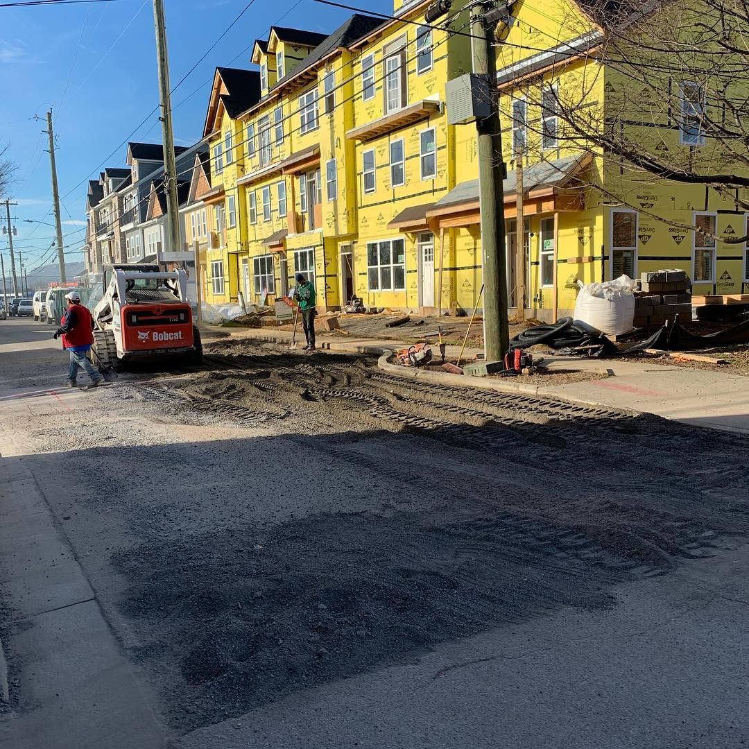 A row of yellow houses are being built in a city