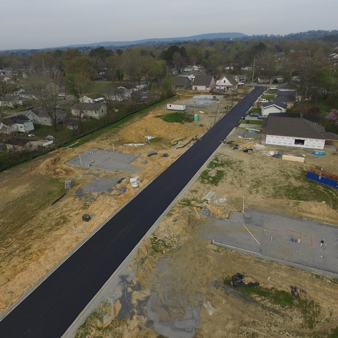 An aerial view of a road going through a residential area.