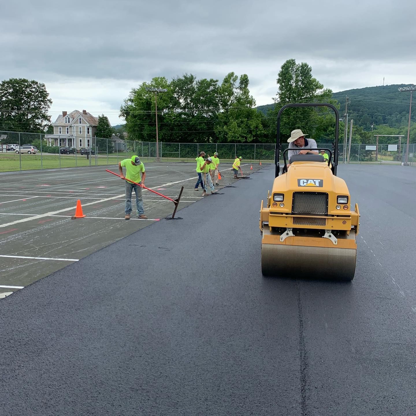 A group of construction workers are working on a road