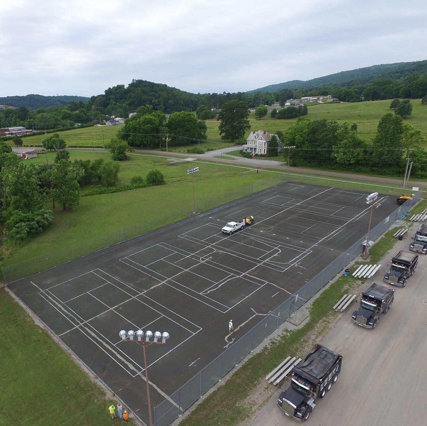 An aerial view of a parking lot with cars parked in it