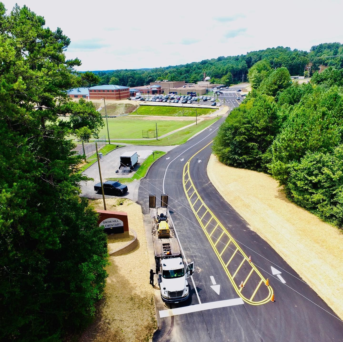 An aerial view of a highway surrounded by trees
