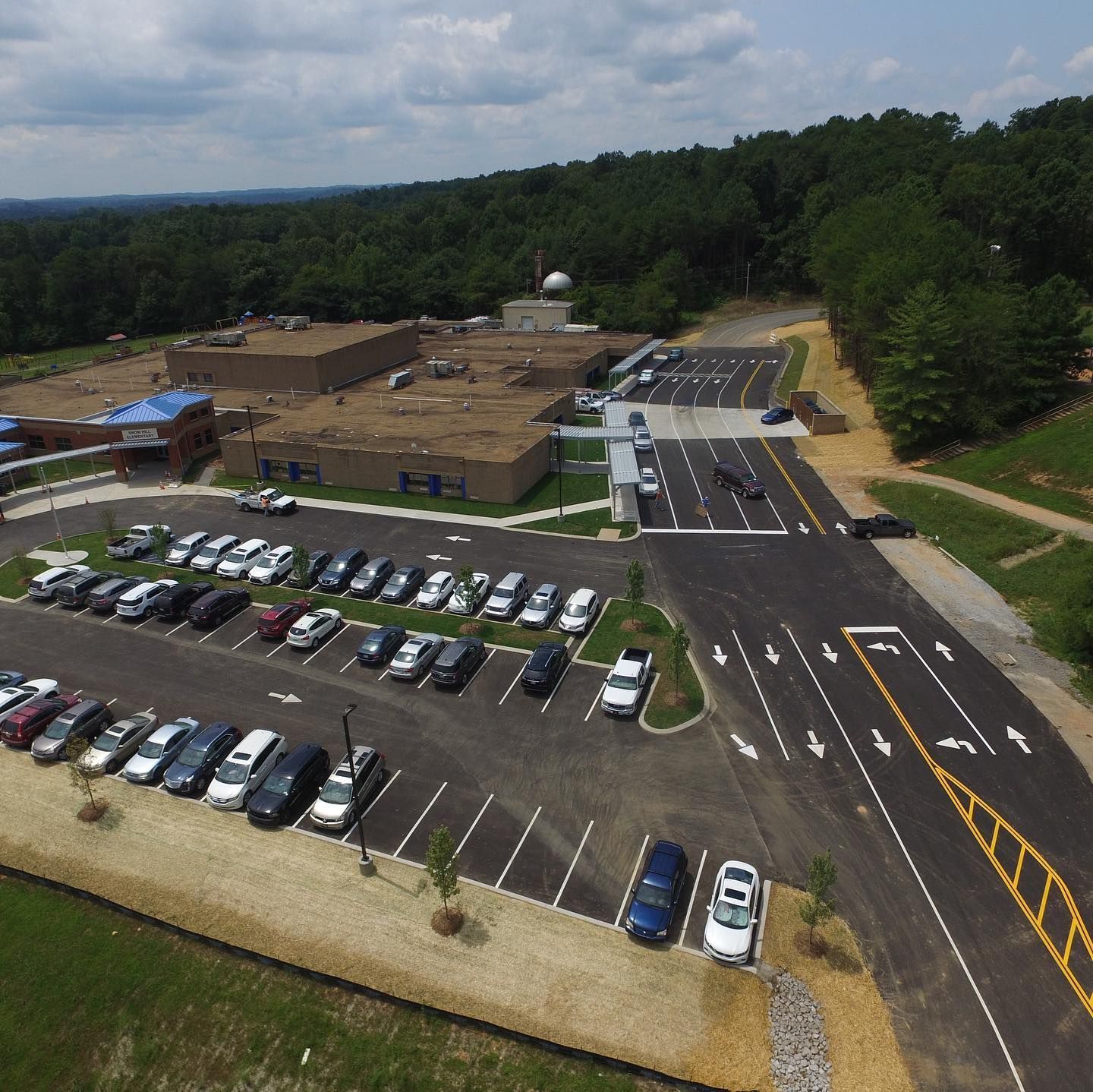An aerial view of a parking lot in front of a building