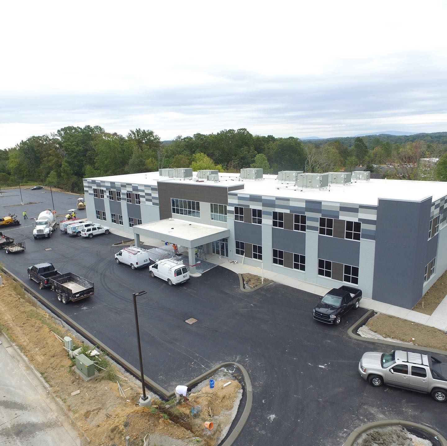 An aerial view of a large building with cars parked in front of it