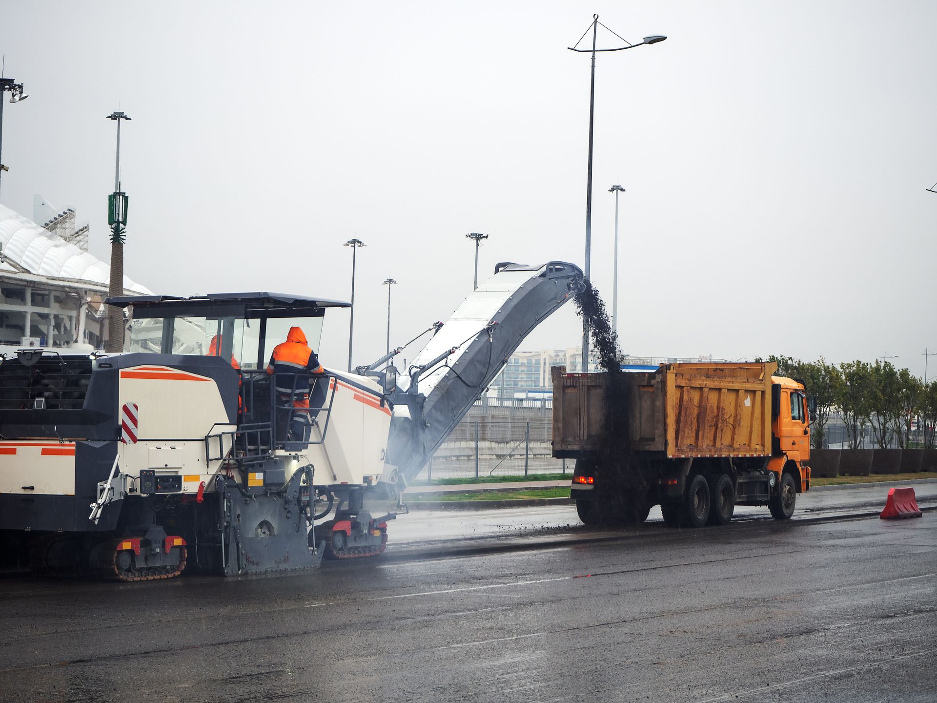 A cat bulldozer is driving down a dirt road
