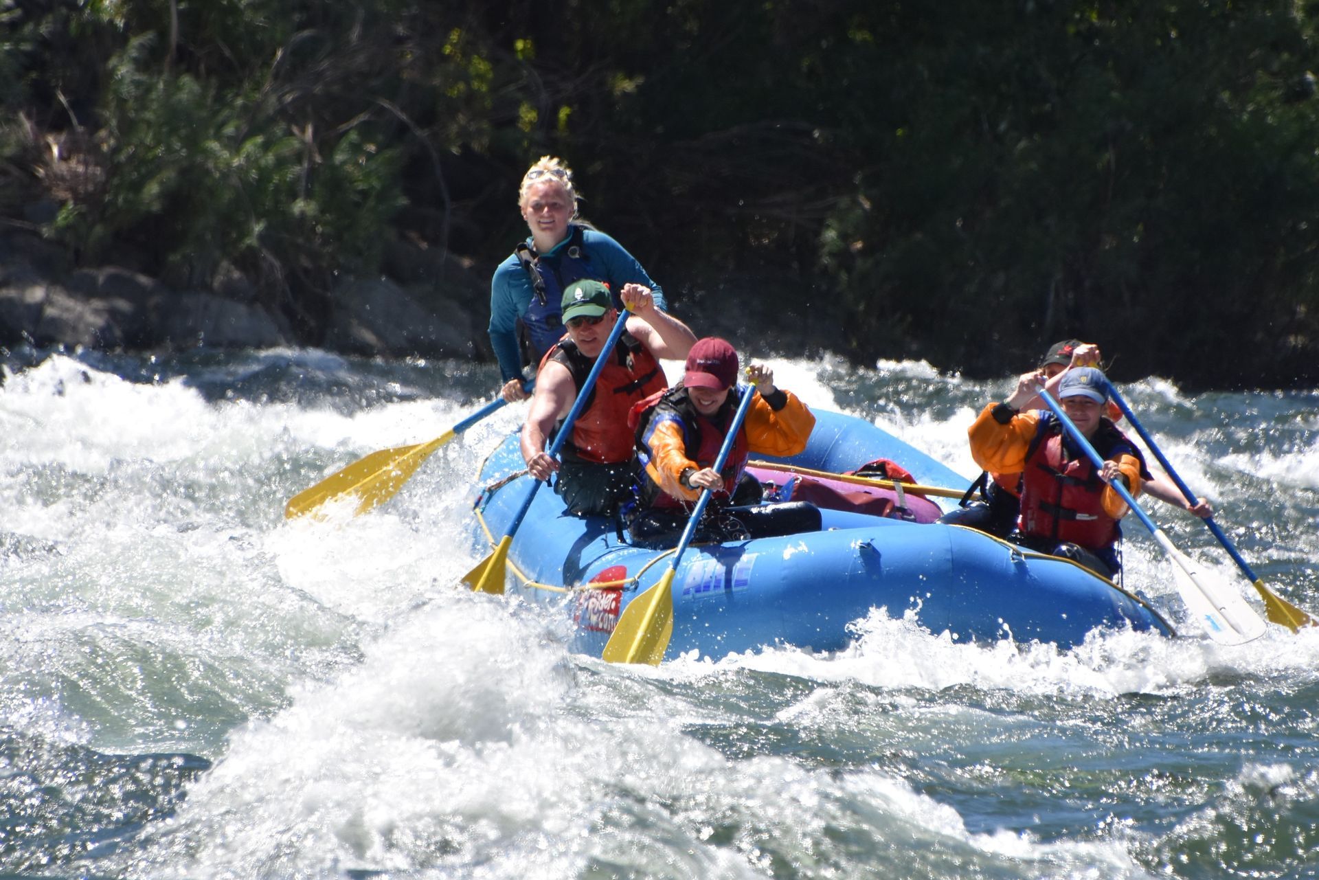 A group of people are rafting down a river