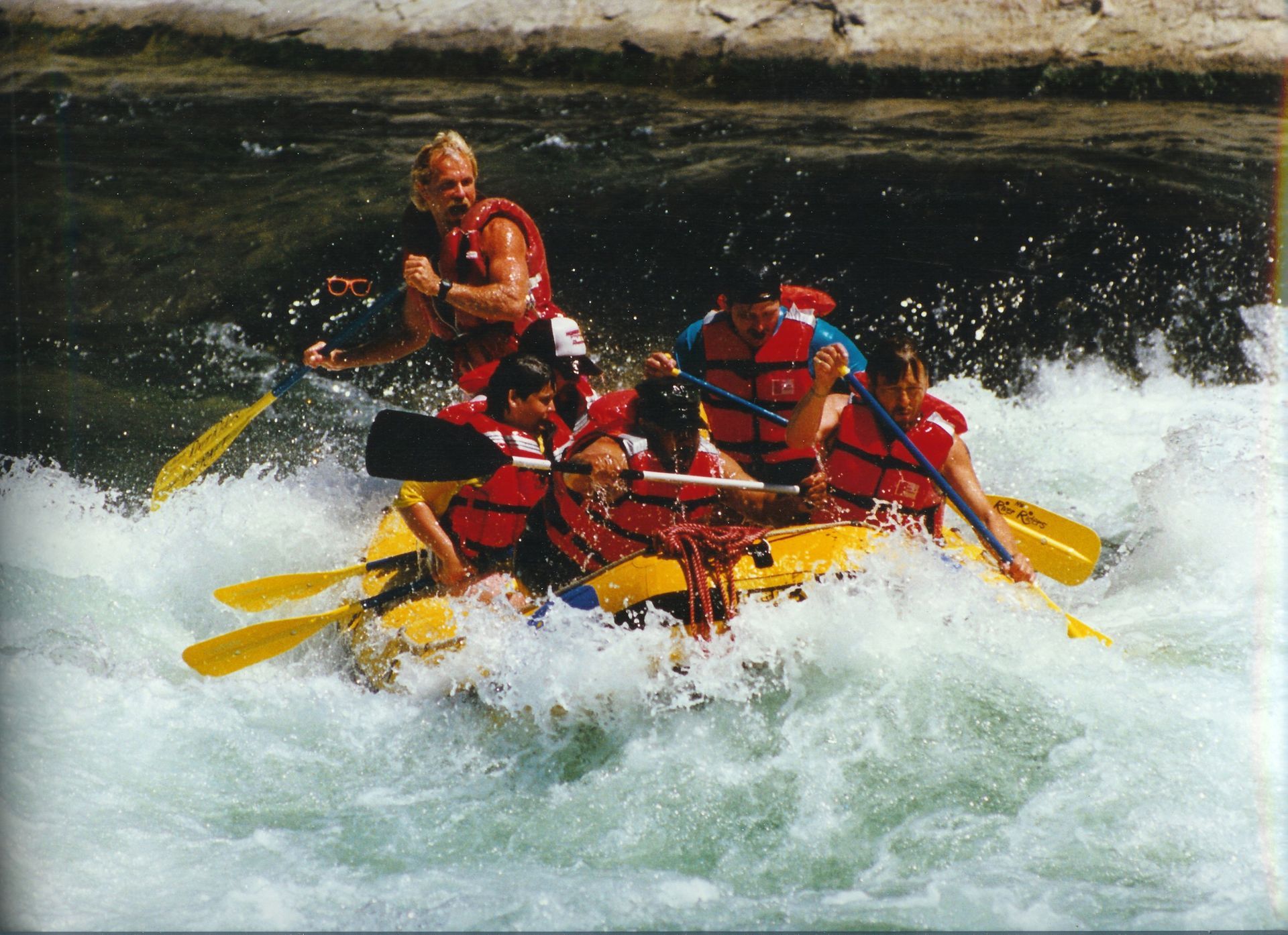 A group of people are rafting down a river