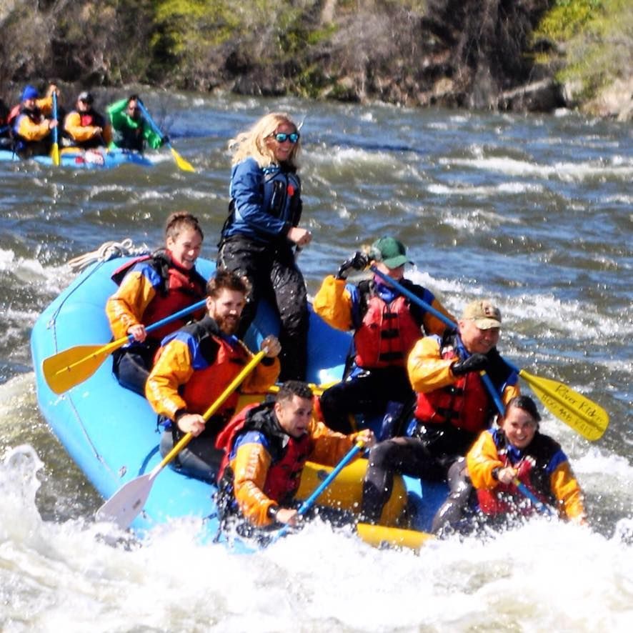 A group of people are rafting down a river