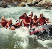 A group of people are rafting down a river.