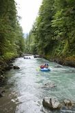 A group of people are floating down a river in a tube.