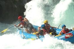 A group of people are rafting down a river in a raft.