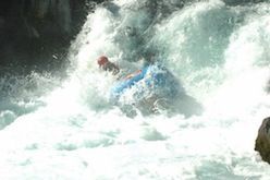 A person is riding a raft down a river.